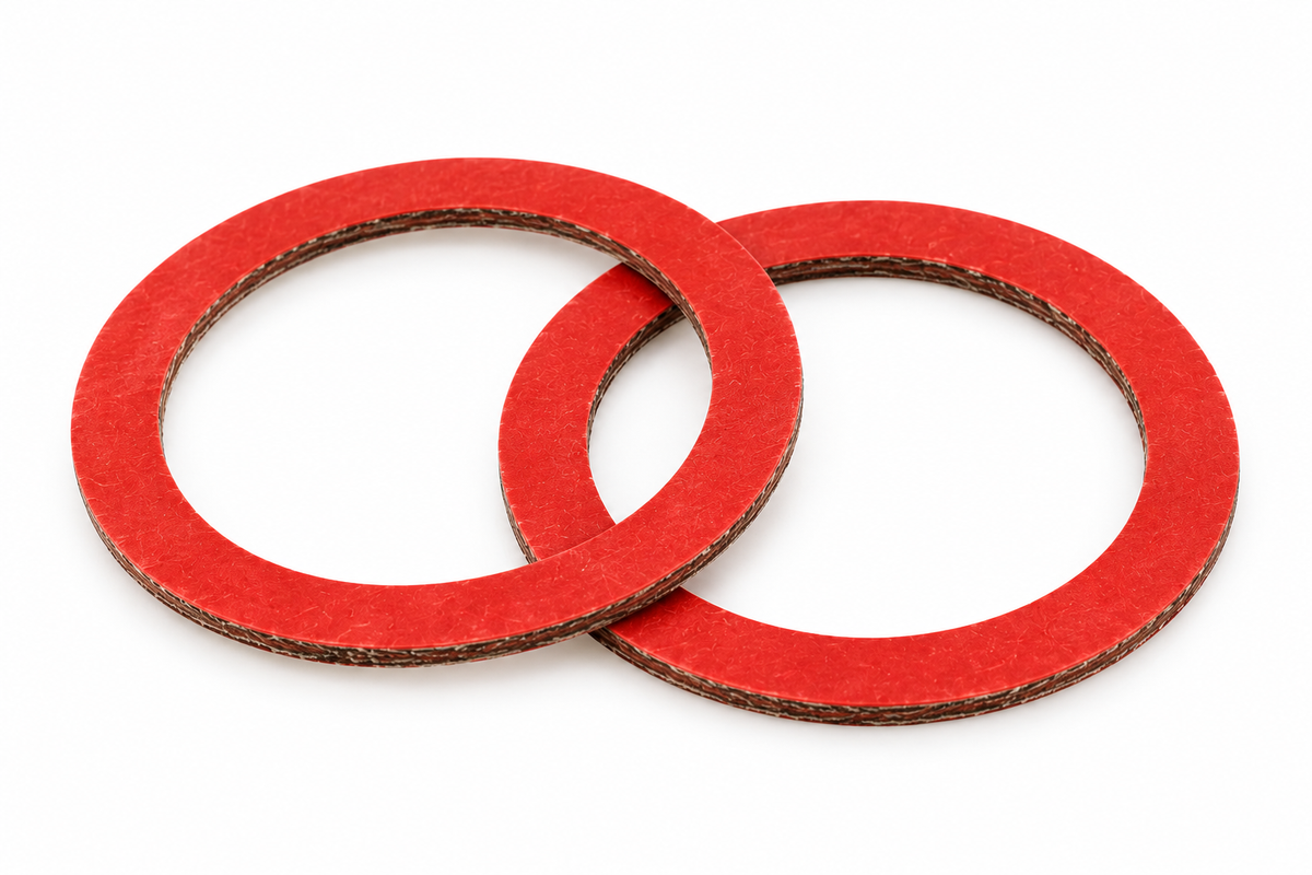 Two red 1½ inch fibre pump union replacement gaskets on a clean white background